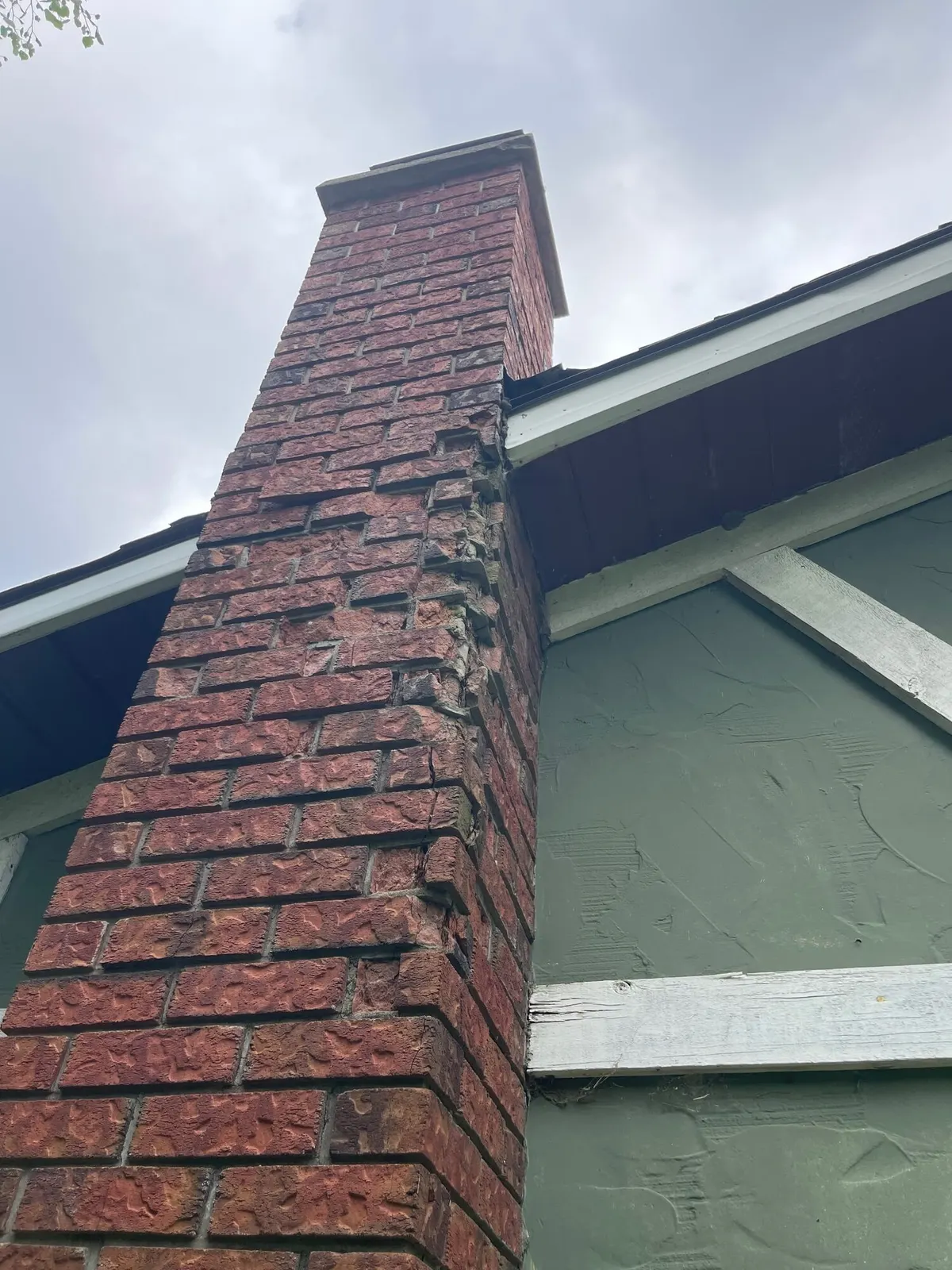 Spalled, crumbling brick chimney before the rebuild